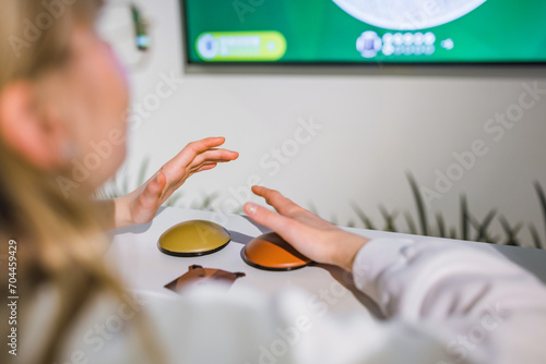 Quadro su tela Female Student at a Quiz Competition with Hands on a Button