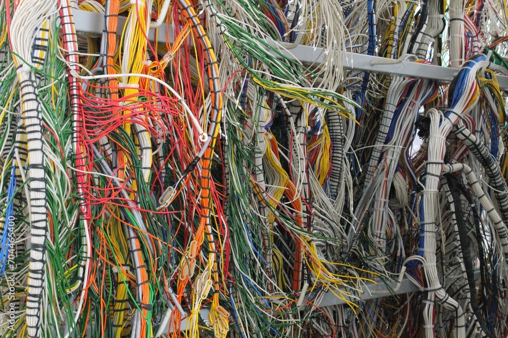 Fiber optic cables and wires in network server room data center. Network panel, switch cable in data center. Reliable LAN internet equipment. Efficient management. Close up of powerful router Fiber optic cables and wires in network server room data center. Network panel, switch cable in data center. Reliable LAN internet equipment. Efficient management. Close up of powerful router