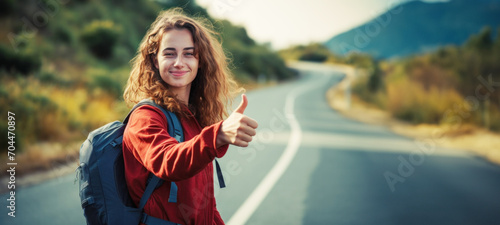 Travel woman backpacking hitchhiking thumbs up  by the road during vacation trip enjoying summertime freedom, traveling by auto stop on the road background