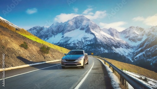car moving on the mountain road against snowcapped mountain