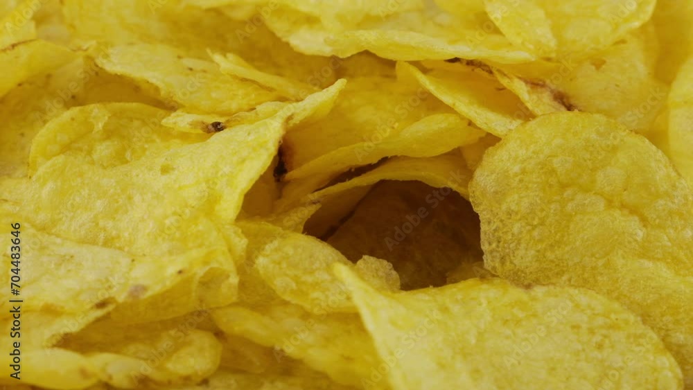 Potato chips rotating close up on culinary parchment. Potato chips rotating close up on culinary parchment.