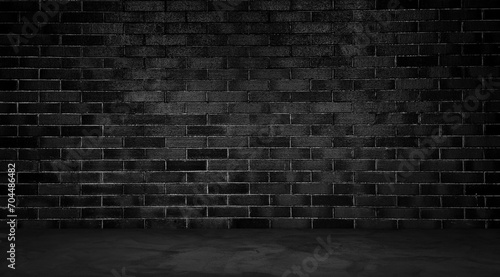 dark room with concrete floor and black brick wall background. empty room for montage product displayed in rustic  industrial  loft mood and tone. room interior with brick wall and cement floor.