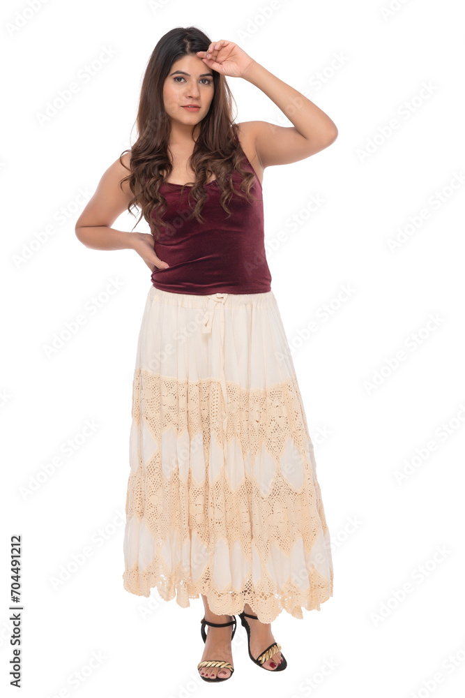 Young Indian girl wearing red velvet top and creamy and lacy long skirt with elegant pose and expression Young Indian girl wearing red velvet top and creamy and lacy long skirt with elegant pose and expression