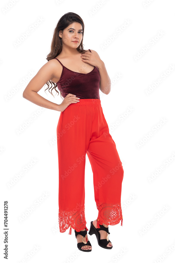 Young Indian girl wearing red velvet top and red lacy pants with elegant pose and expression Young Indian girl wearing red velvet top and red lacy pants with elegant pose and expression