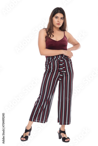 Young Indian girl wearing red velvet top and stripped pants with elegant pose and expression