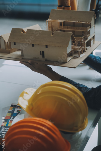 Construction and structure concept of Engineer or architect meeting for project working with partner and engineering tools on model building and blueprint in working site, contract for both companies.