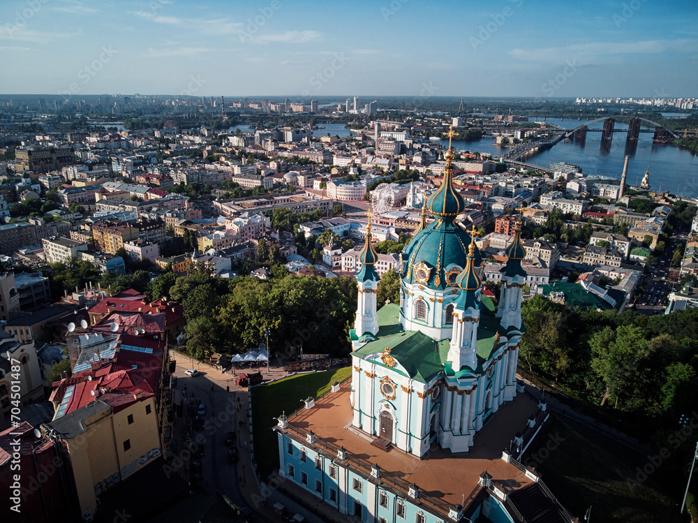 Aerial top view of Saint Andrew's church and Andreevska street from above, cityscape of Podol district, city of Kyiv, Ukraine