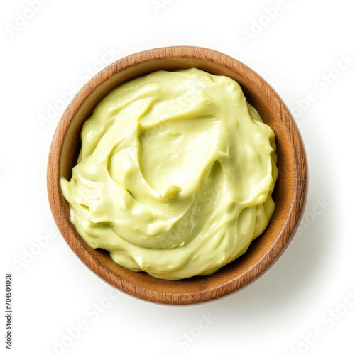 Top view of wasabi mayo in a wooden bowl isolated on a white background