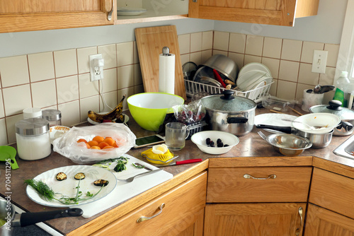 Kitchen mess with dirty utensils and food