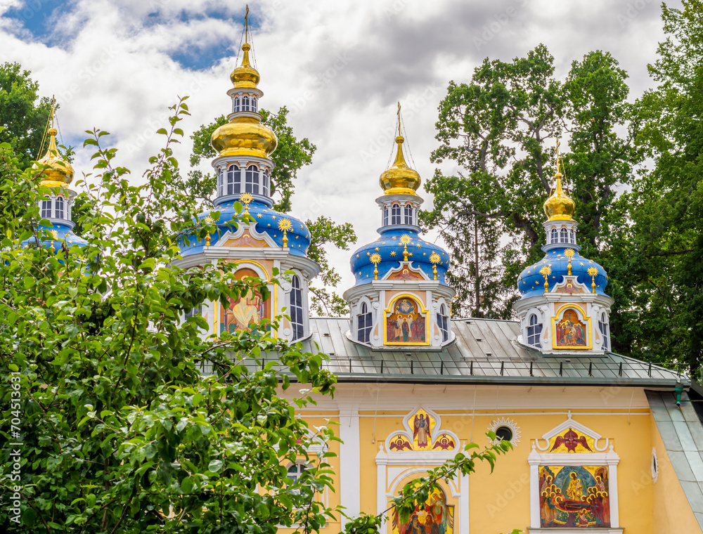 Colorful domes of the Pechora Holy Dormition Pskovo-Pechersky Monastery. Pskov region religion, Christianity history