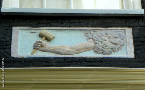 Netherlands, Amsterdam, 21 Eerste Tuindwarsstraat, bas-relief on the wall of the house photo