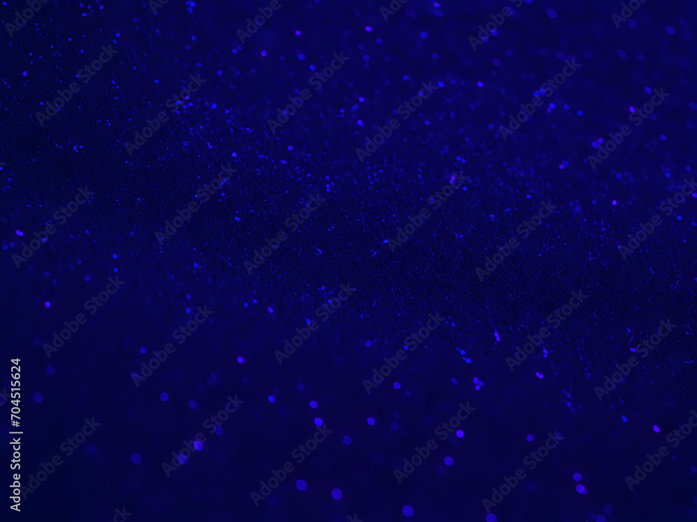 A beautiful abstract blue glitter defocused darker background