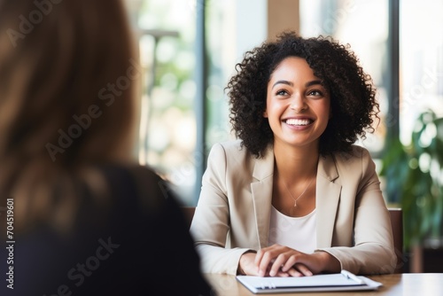 Photo of Happy hiring manager interviewing a job candidate in her office photo