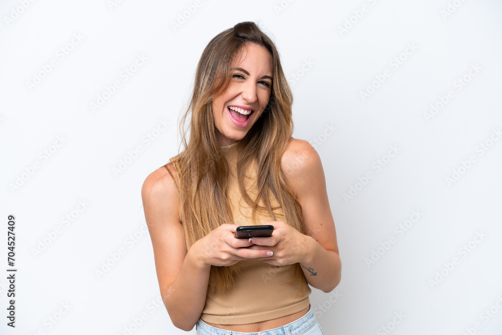 Young caucasian woman isolated on white background surprised and sending a message Young caucasian woman isolated on white background surprised and sending a message