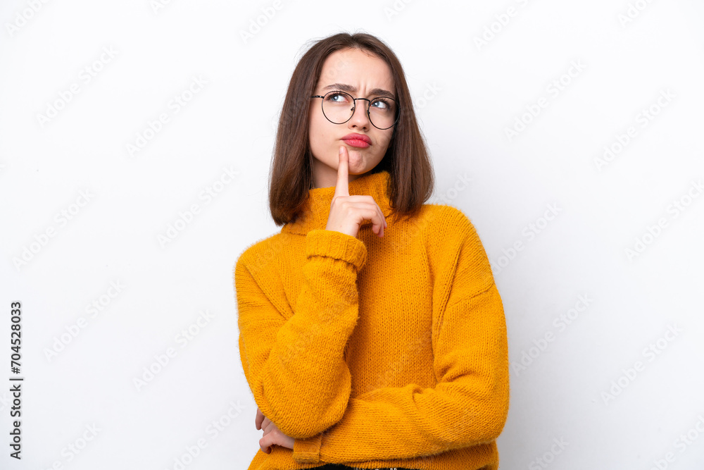 Young Ukrainian woman isolated on white background having doubts while looking up Young Ukrainian woman isolated on white background having doubts while looking up