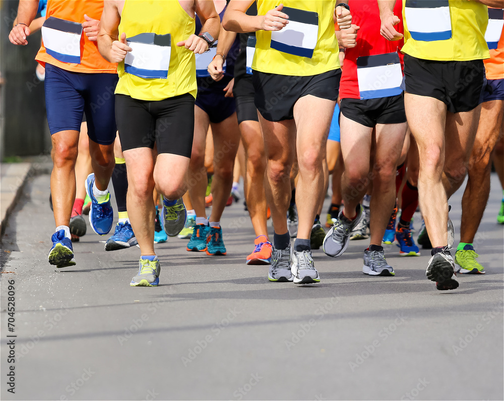 running race with feet and legs of many runners sports athletes