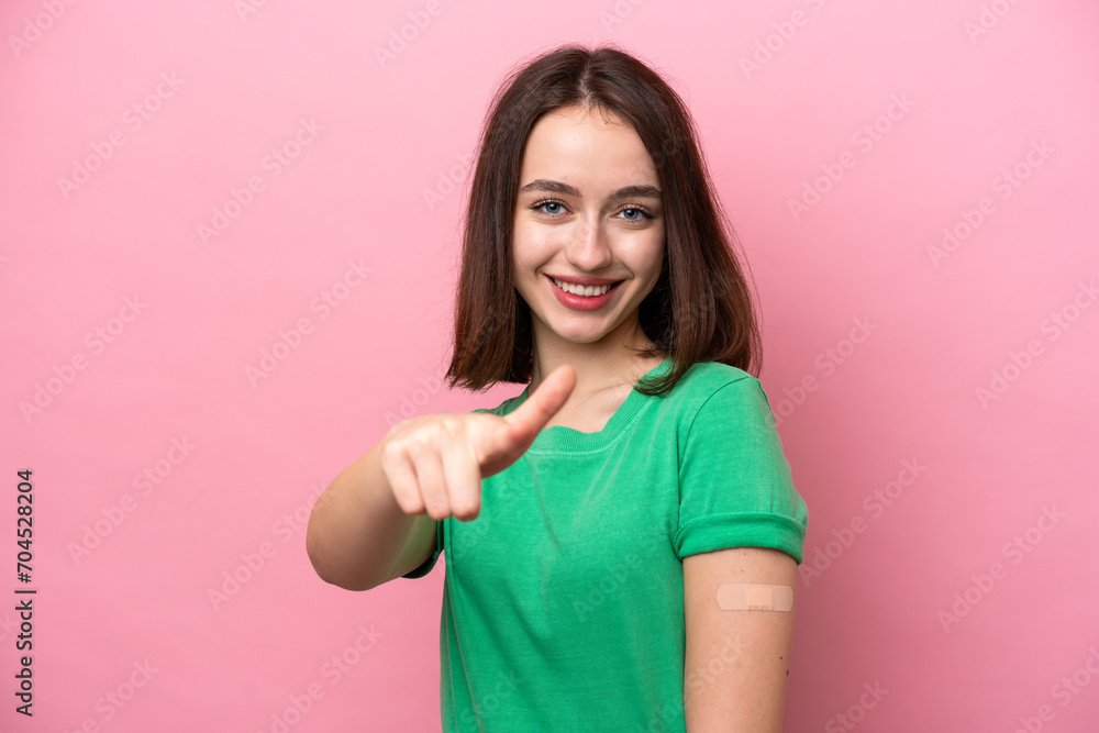 Young Ukrainian woman wearing a band aids points finger at you with a confident expression Young Ukrainian woman wearing a band aids points finger at you with a confident expression