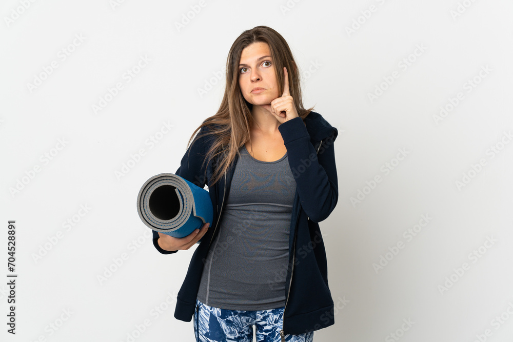 Fototapeta premium Slovak girl going to yoga classes isolated on white background thinking an idea