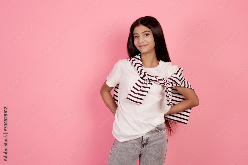 Young smiling teenage girl on pink background in studio. Young smiling teenage girl on pink background in studio.