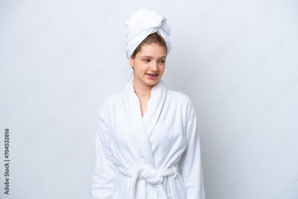 Teenager Russian girl in a bathrobe isolated on white background looking to the side and smiling Teenager Russian girl in a bathrobe isolated on white background looking to the side and smiling