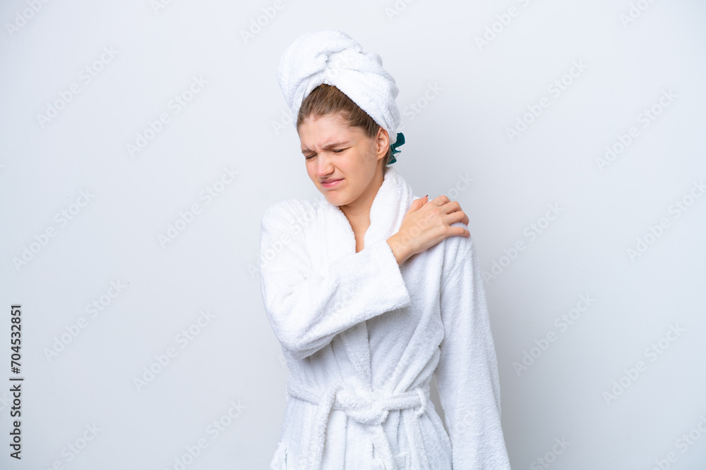 Teenager Russian girl in a bathrobe isolated on white background suffering from pain in shoulder for having made an effort