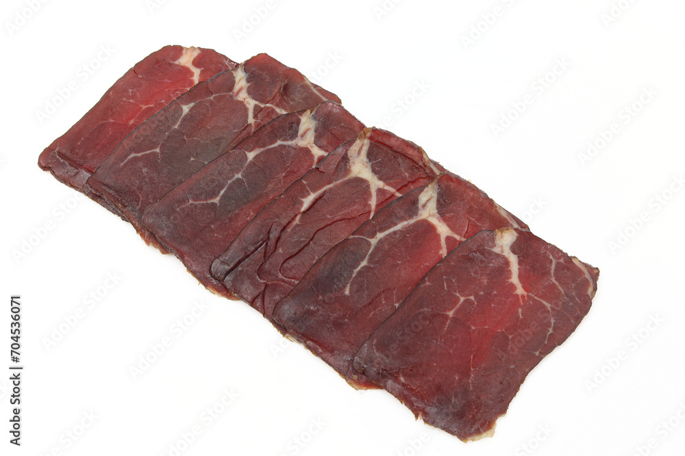 Sliced and served dried beef ham meat isolated on white background Sliced and served dried beef ham meat isolated on white background