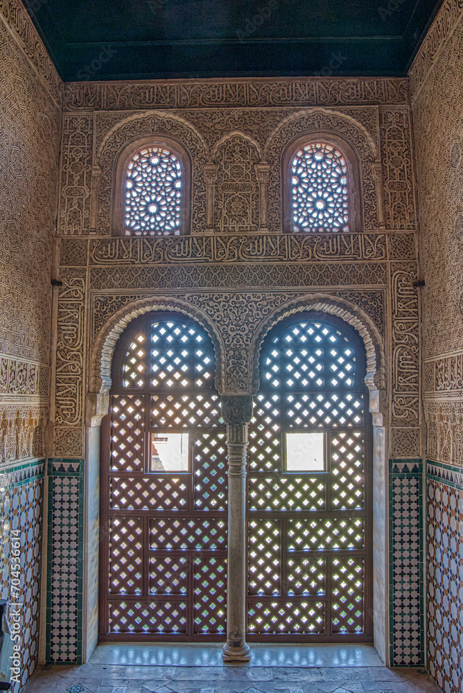 Ornate interior lattice doors and windows of islamic mosque