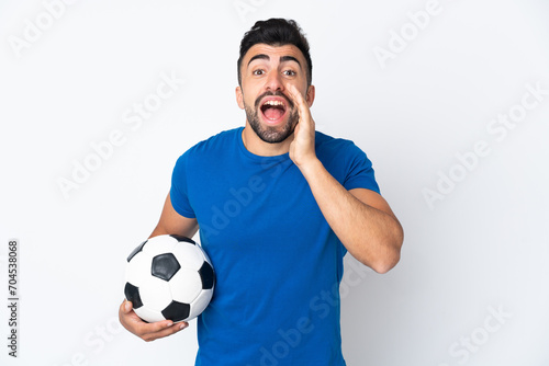 Handsome young football player man over isolated wall shouting with mouth wide open