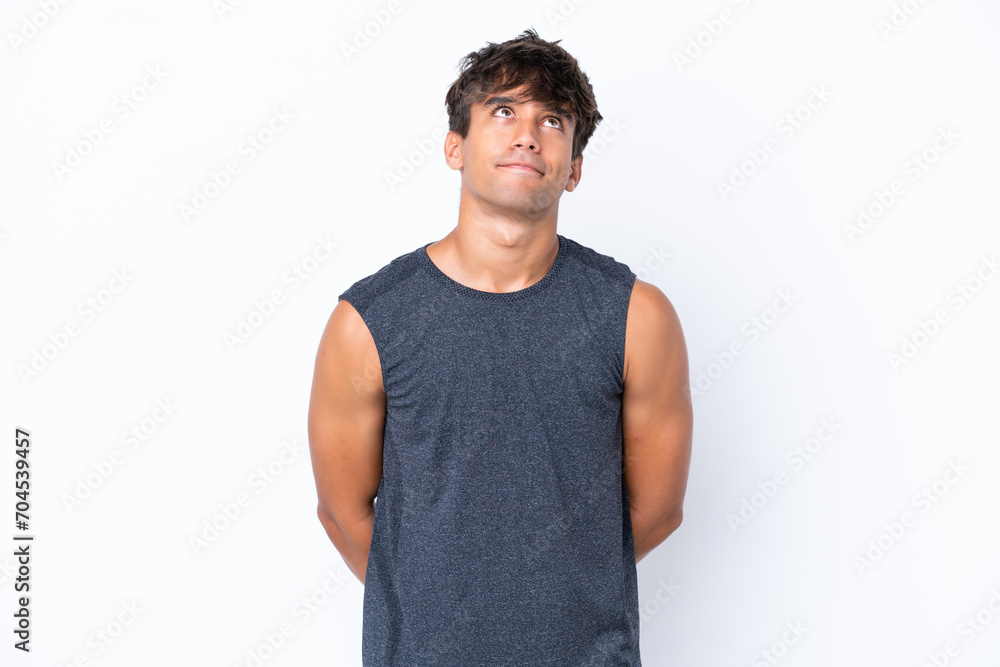 Young sport caucasian man isolated on white background and looking up Young sport caucasian man isolated on white background and looking up