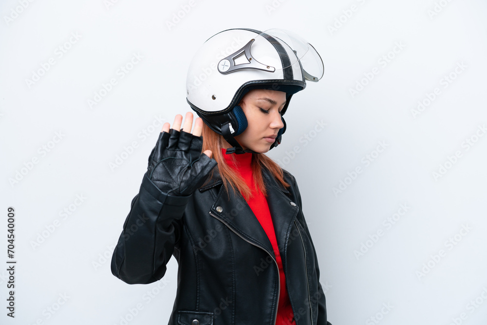 Young Russian girl with a motorcycle helmet isolated on white background making stop gesture and disappointed Young Russian girl with a motorcycle helmet isolated on white background making stop gesture and disappointed
