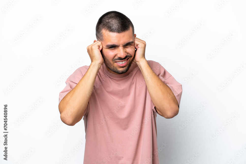 Young caucasian man isolated on white background frustrated and covering ears Young caucasian man isolated on white background frustrated and covering ears