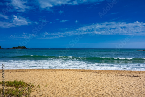 Beach in the afternoon. Prumirim Beach in Ubatuba, São Paulo, Brazil, on a sunny day with blue skies.