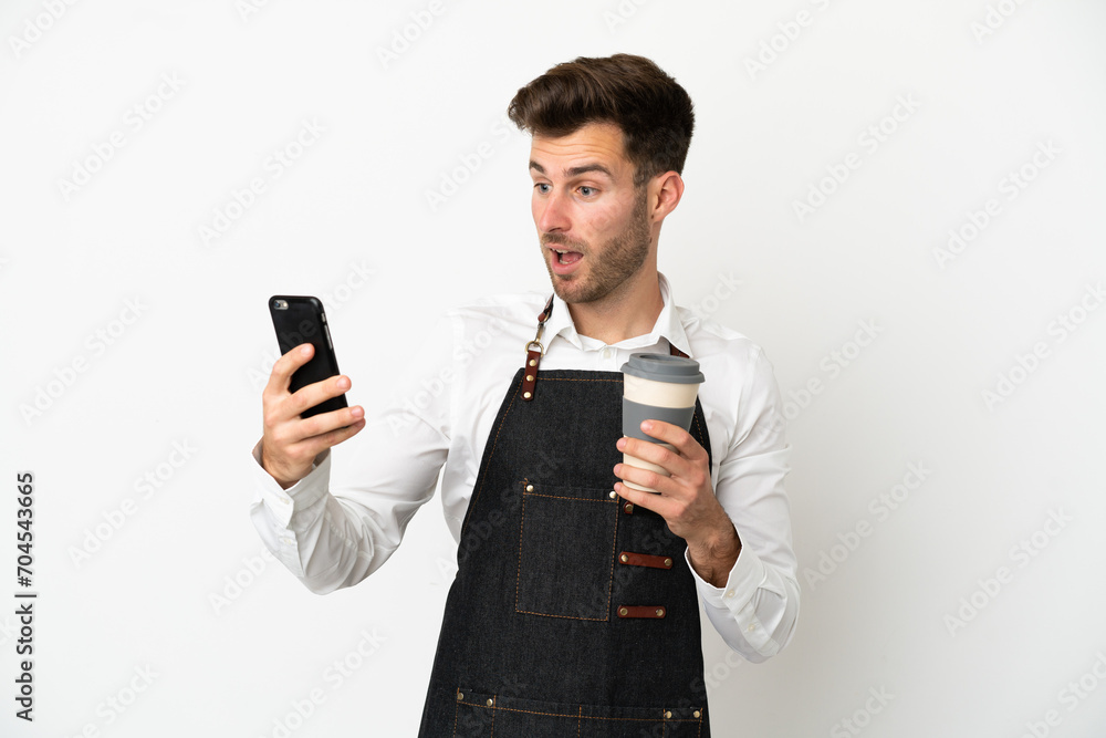 Restaurant caucasian waiter isolated on white background holding coffee to take away and a mobile Restaurant caucasian waiter isolated on white background holding coffee to take away and a mobile