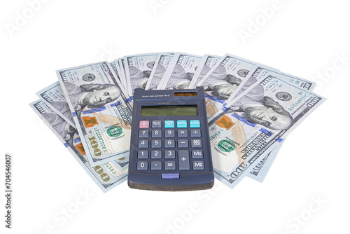 Calculator on a pile of money in hundred dollar bills on a white background. Finance and business concept