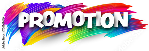 Promotion paper word sign with colorful spectrum paint brush strokes over white.