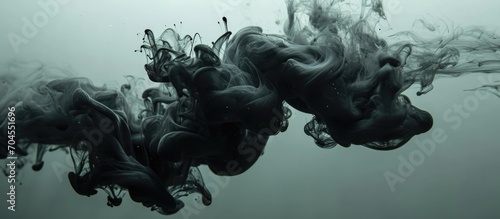 Black paint suspended in murky water. photo