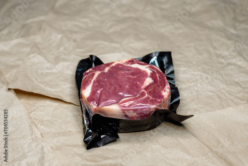 fresh beef in vacuum packaging on a background of kraft paper photo