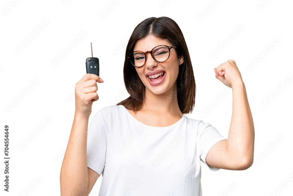 Young Russian woman holding car keys over isolated chroma key background celebrating a victory Young Russian woman holding car keys over isolated chroma key background celebrating a victory