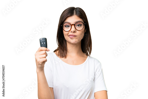 Young Russian woman holding car keys over isolated chroma key background with sad expression