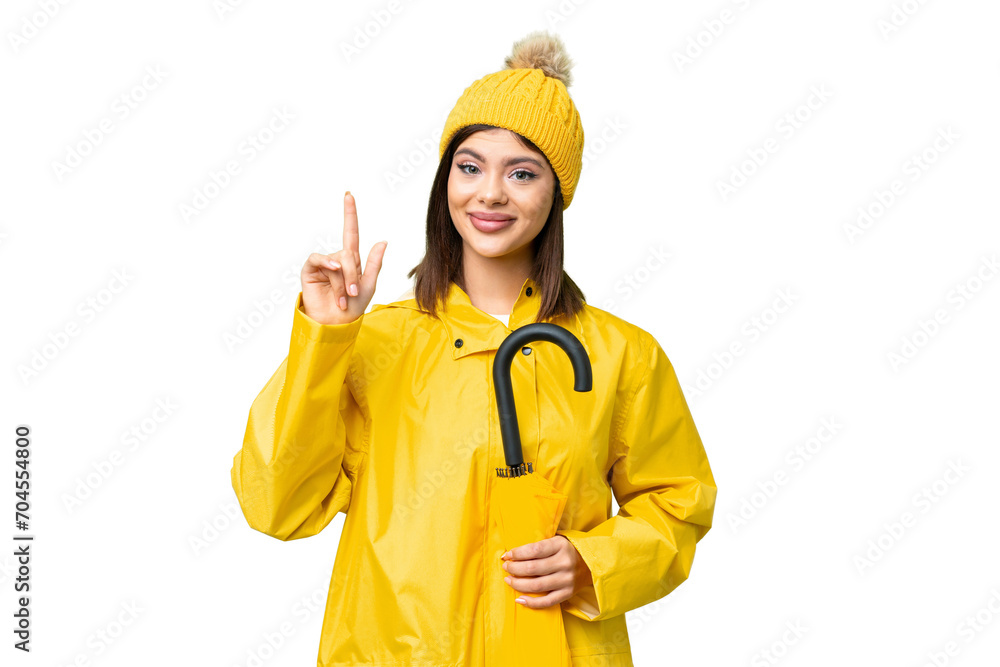 Young Russian woman with rainproof coat and umbrella over isolated chroma key background pointing up a great idea Young Russian woman with rainproof coat and umbrella over isolated chroma key background pointing up a great idea