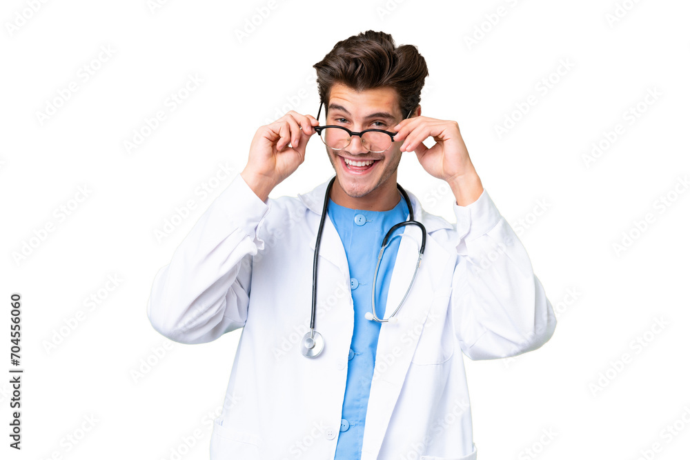 Young doctor man over isolated background with glasses and surprised Young doctor man over isolated background with glasses and surprised