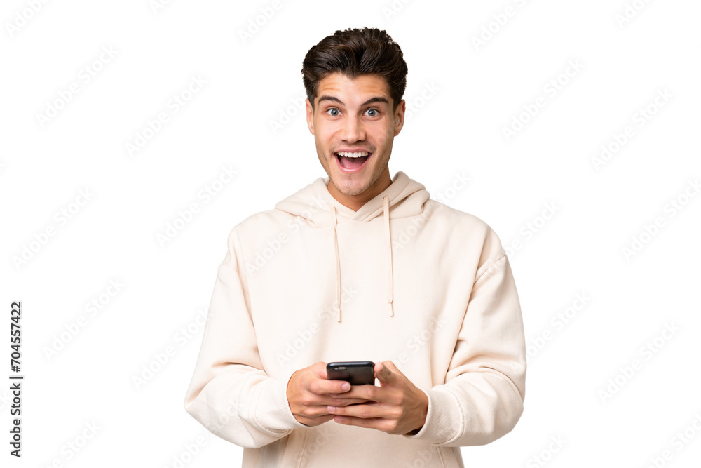Young caucasian handsome man over isolated background surprised and sending a message Young caucasian handsome man over isolated background surprised and sending a message