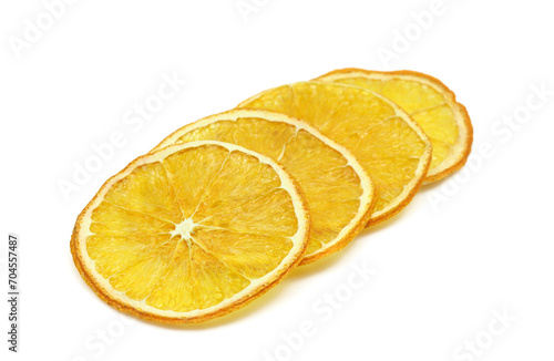 Stacked dehydrated slices of dried orange isolated on white background