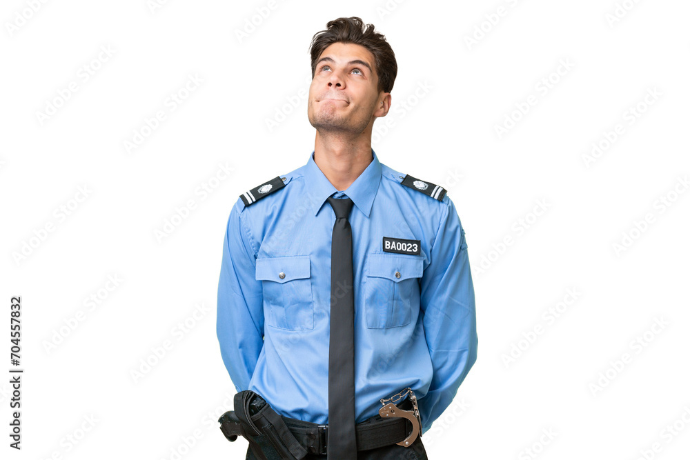 Young police man over isolated background and looking up Young police man over isolated background and looking up