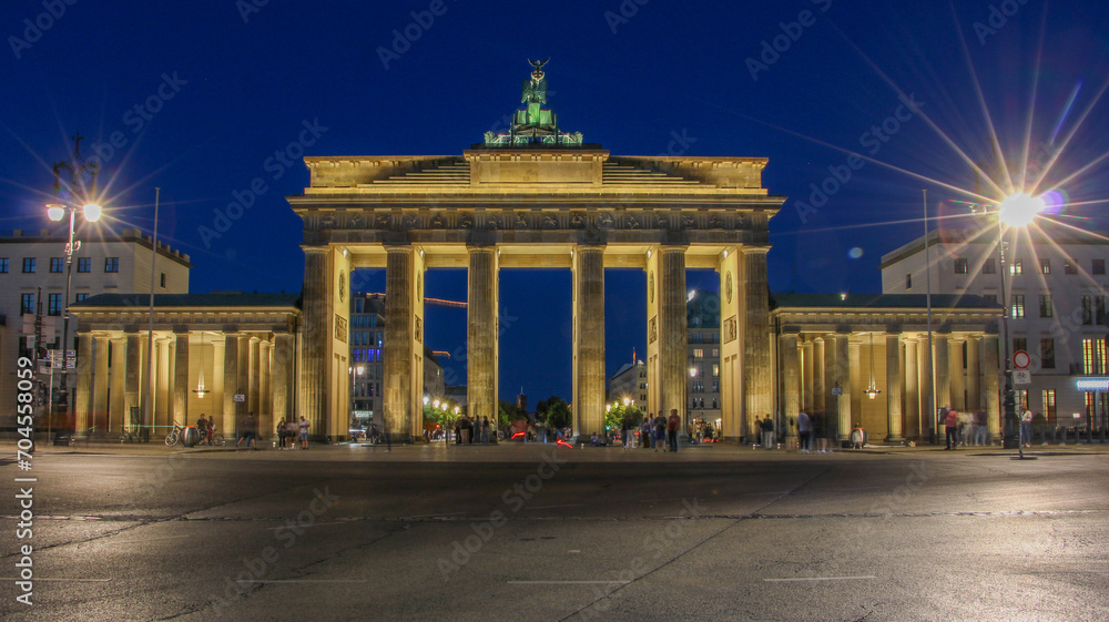 Brandenburg Arch in Berlin illuminated in the night sky