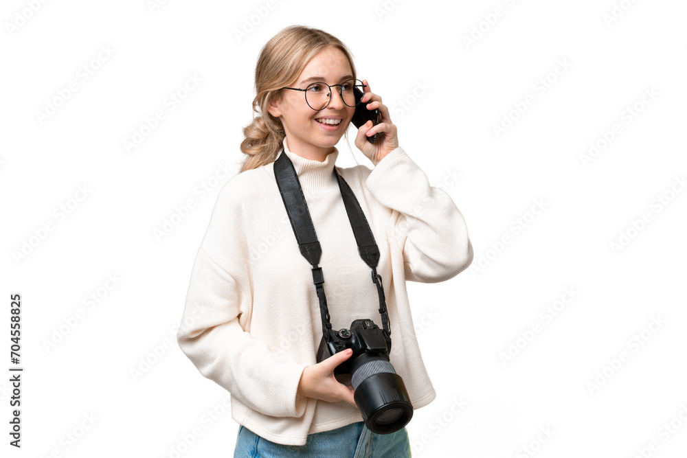 Young photographer English woman over isolated background keeping a conversation with the mobile phone Young photographer English woman over isolated background keeping a conversation with the mobile phone