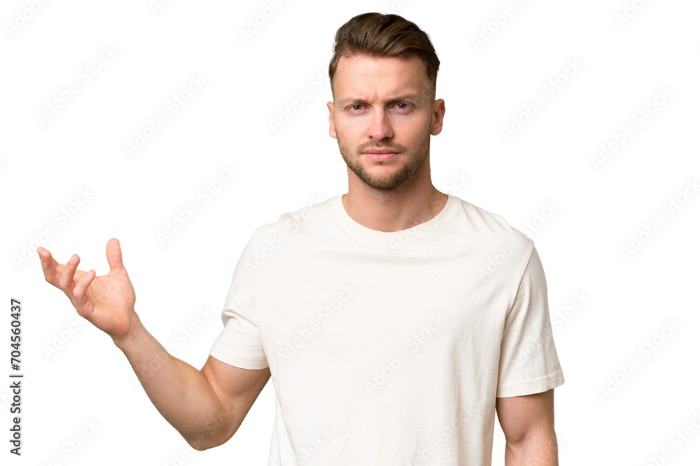 Young blonde caucasian man over isolated background making doubts gesture Young blonde caucasian man over isolated background making doubts gesture