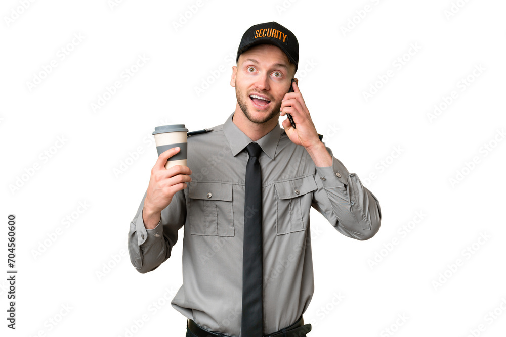 Young security caucasian man over isolated background holding coffee to take away and a mobile Young security caucasian man over isolated background holding coffee to take away and a mobile