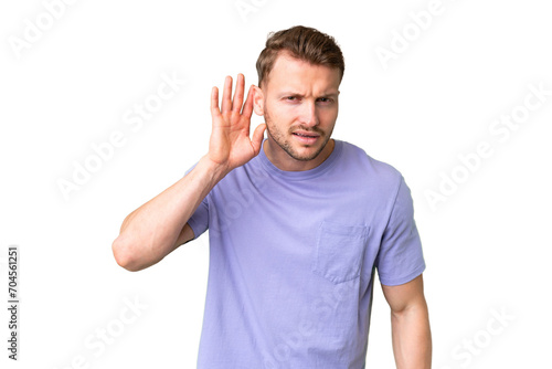 Young handsome caucasian man over isolated chroma key background listening to something by putting hand on the ear
