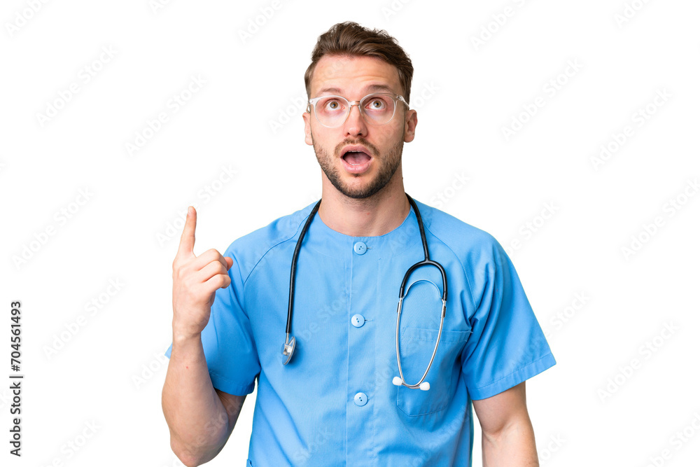 Young nurse man over isolated chroma key background pointing up and surprised Young nurse man over isolated chroma key background pointing up and surprised